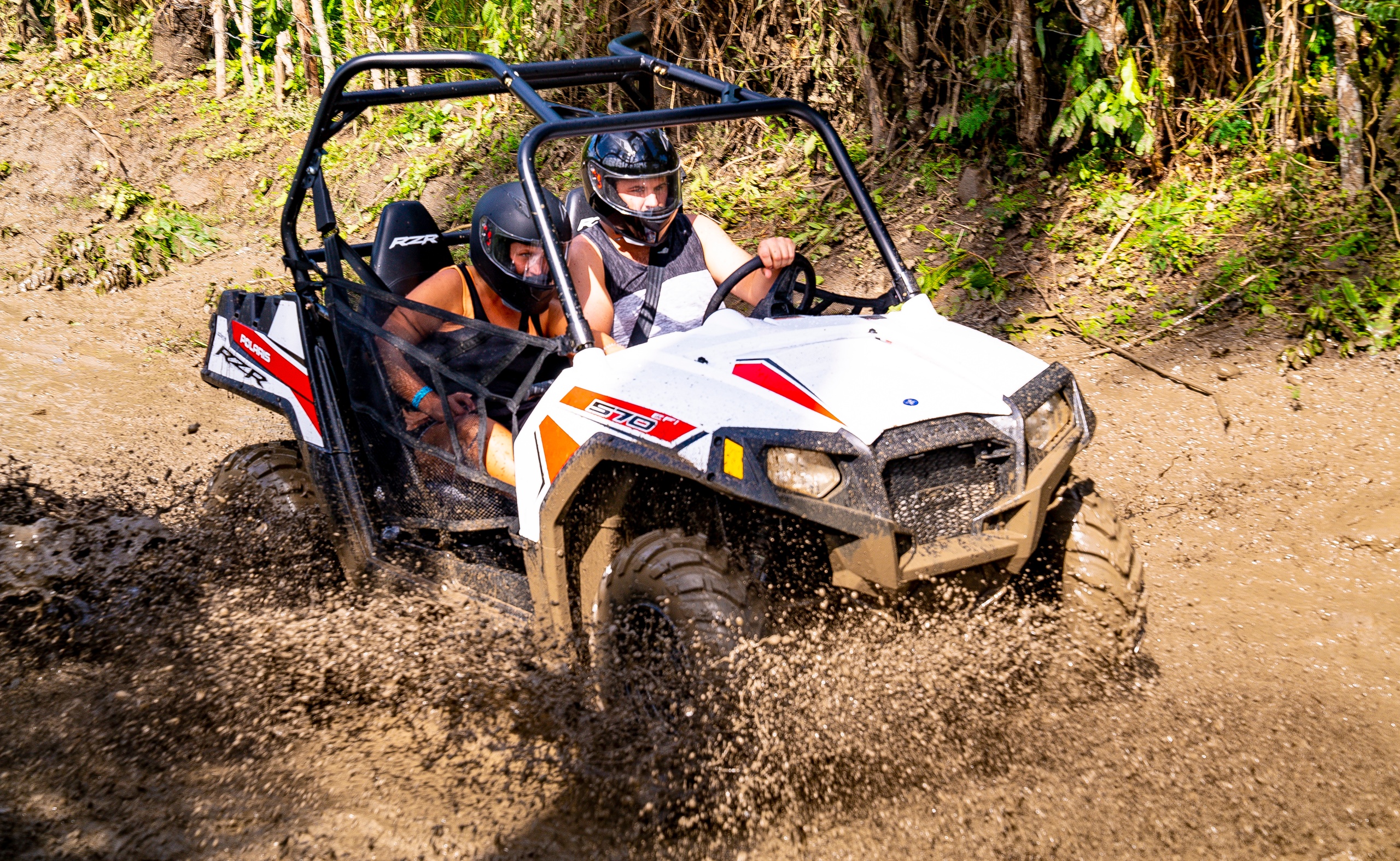 a person riding a motorcycle down a dirt road